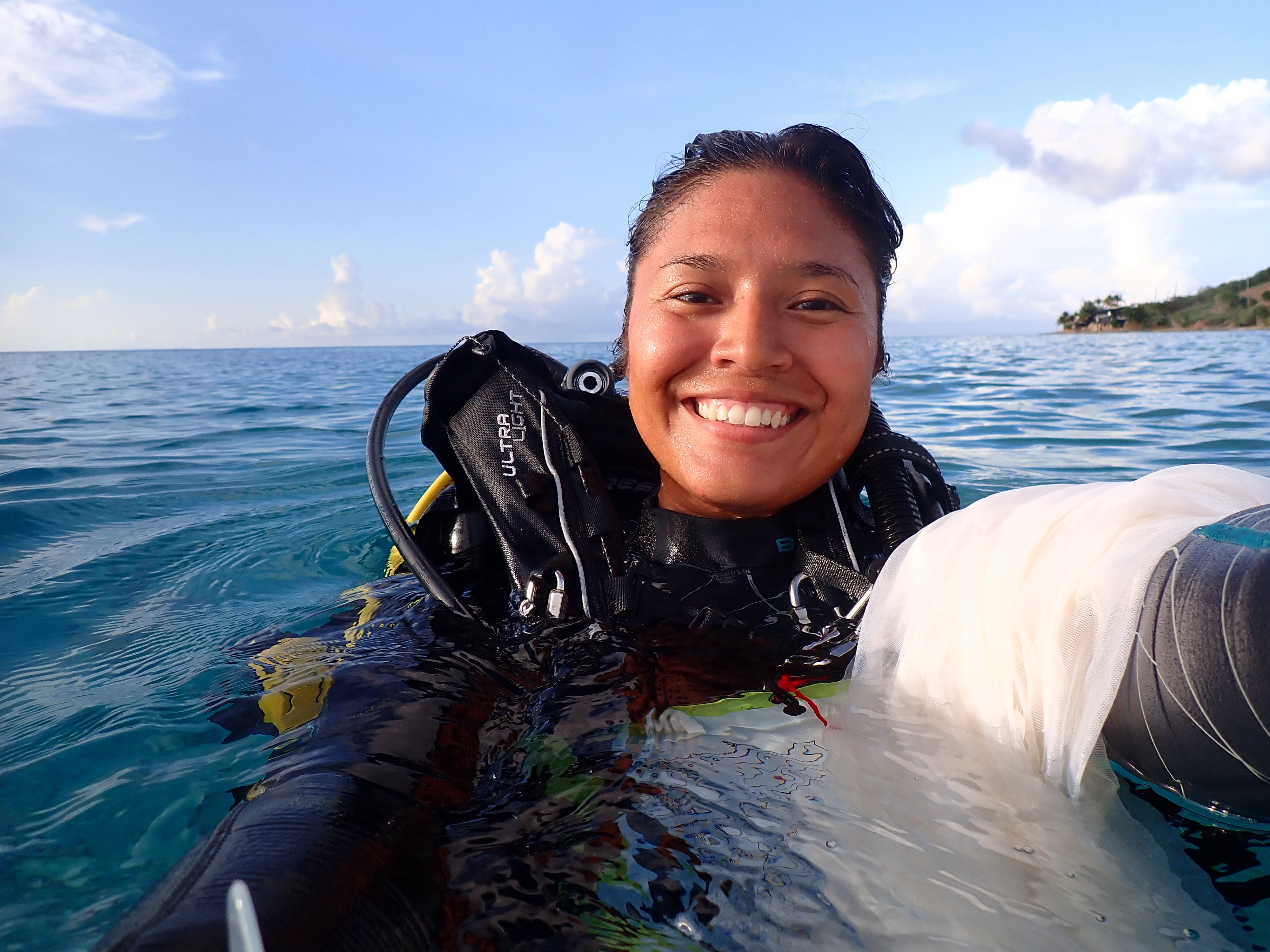 Daisy taking a selfie in the ocean with her scuba gear