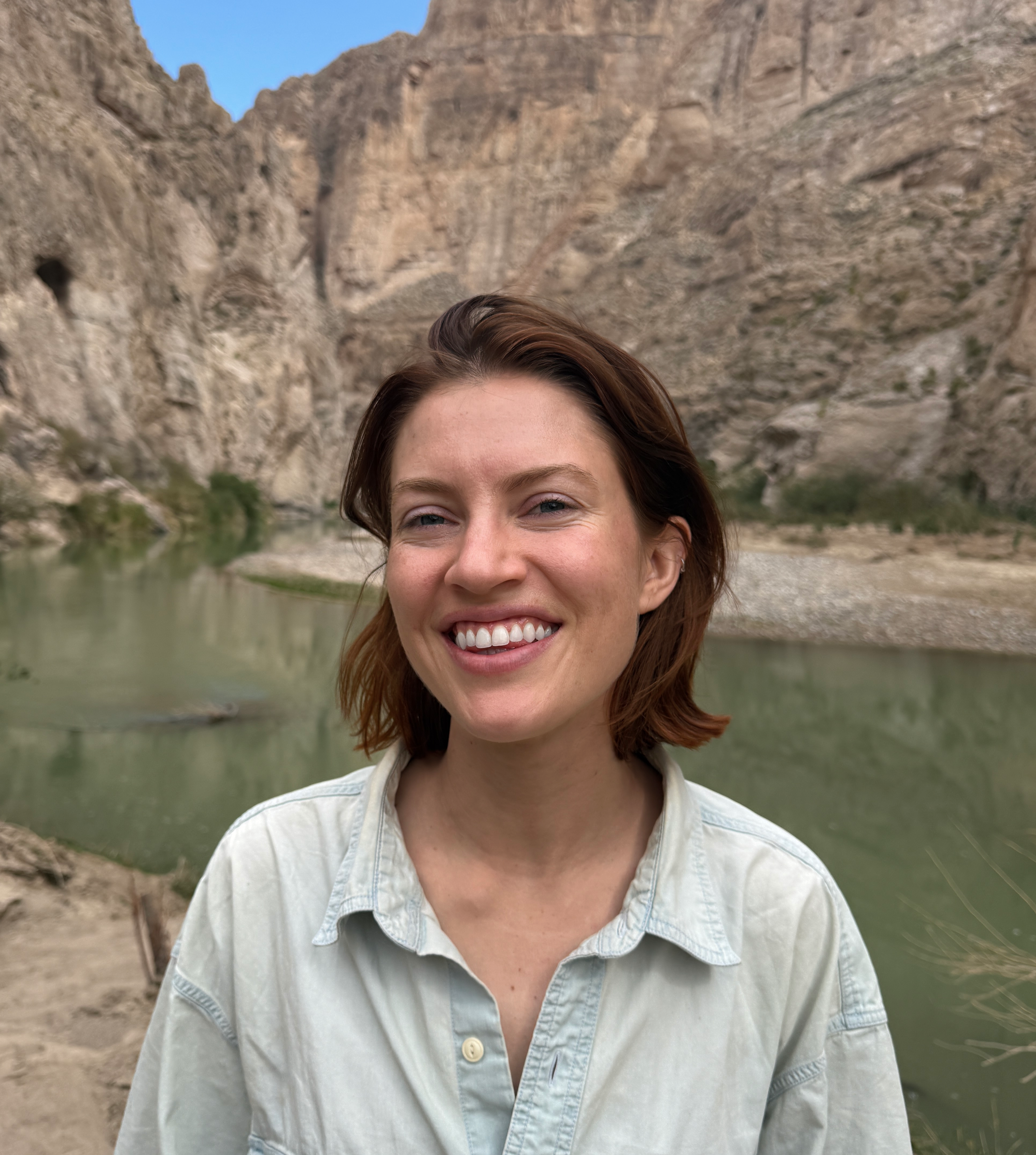 Elena posing in front of a canyon valley